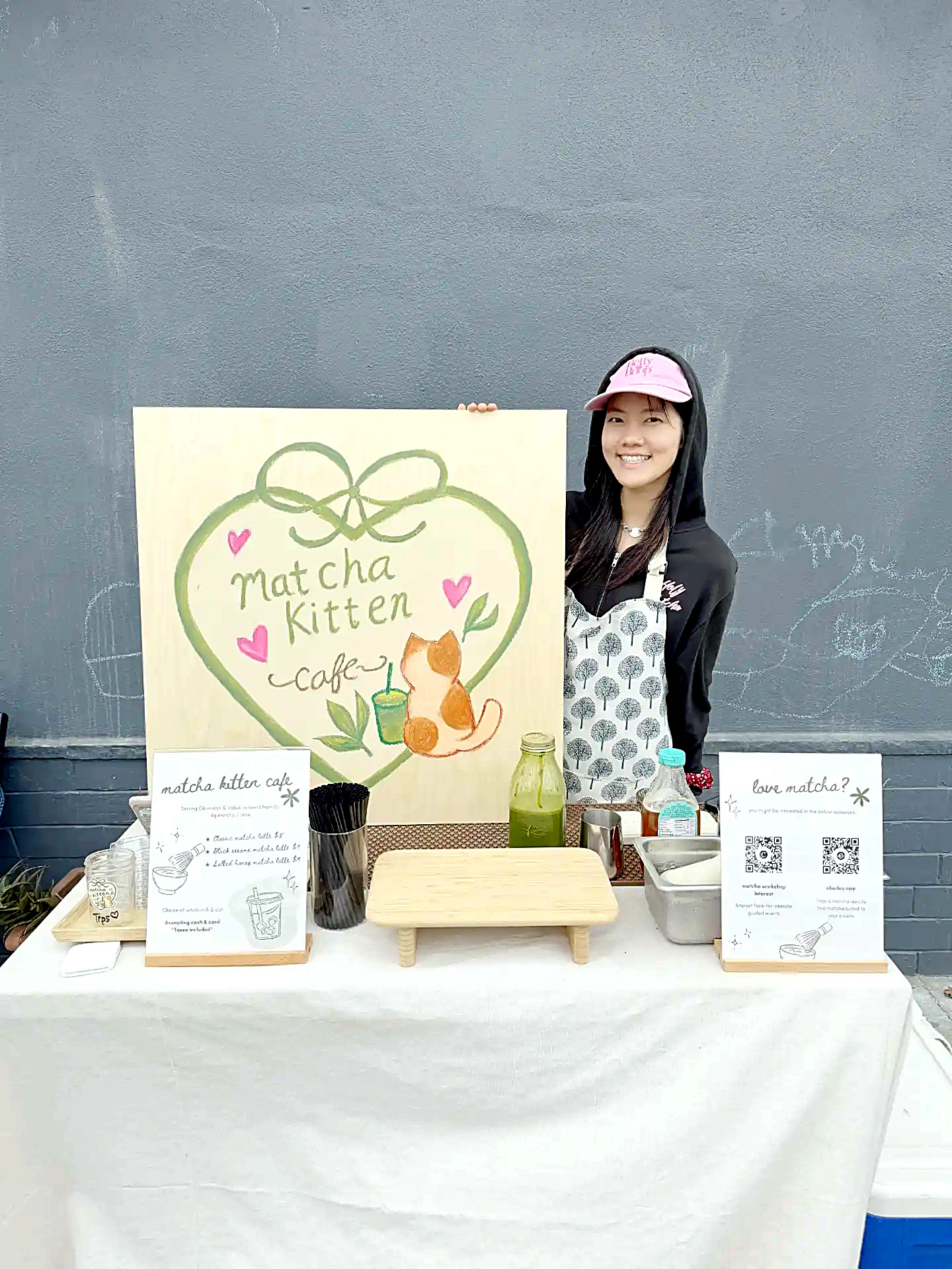 Esther behind the Matcha Kitten Cafe pop-up stand